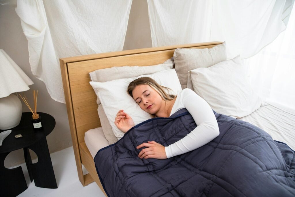 Do Weighted Blankets Actually Help with Anxiety? Person sleeping peacefully under a heavy blanket