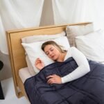 Do Weighted Blankets Actually Help with Anxiety? Person sleeping peacefully under a heavy blanket