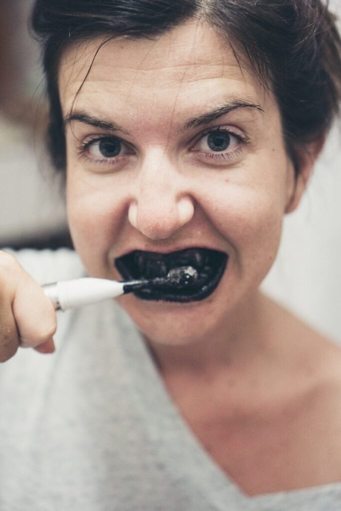 Person brushing teeth with electric toothbrush