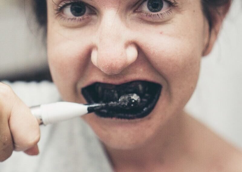 Person brushing teeth with electric toothbrush