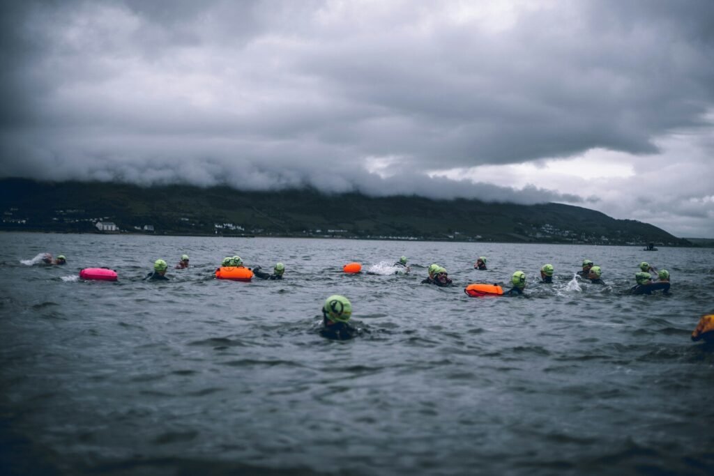 Best Swim Goggles for Open Water - Open water swimmer sighting in lake at sunrise