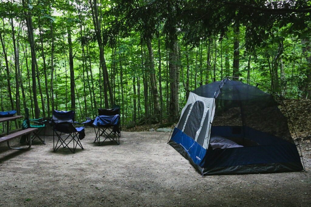 Large cabin tent set up at a family campsite with chairs outside