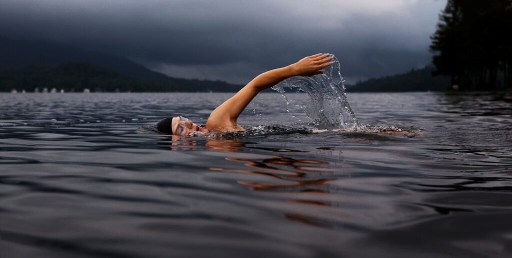 Triathlete swim with goggles in open water