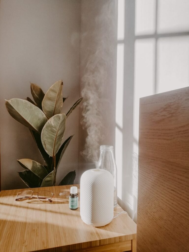 Cool Mist vs Warm Mist Humidifier - White humidifier emitting cool mist on bedroom nightstand