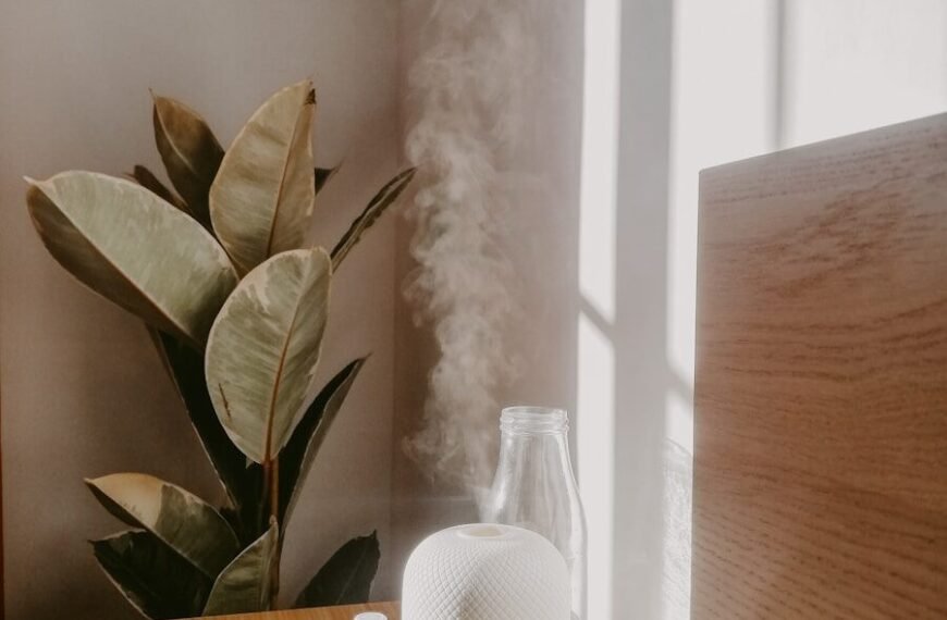 Cool Mist vs Warm Mist Humidifier - White humidifier emitting cool mist on bedroom nightstand
